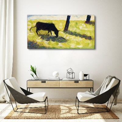 Obraz Canvas Pasąca się krowa w zielonym krajobrazie